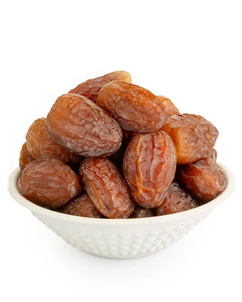 Large Medjool Royal dates in a white bowl